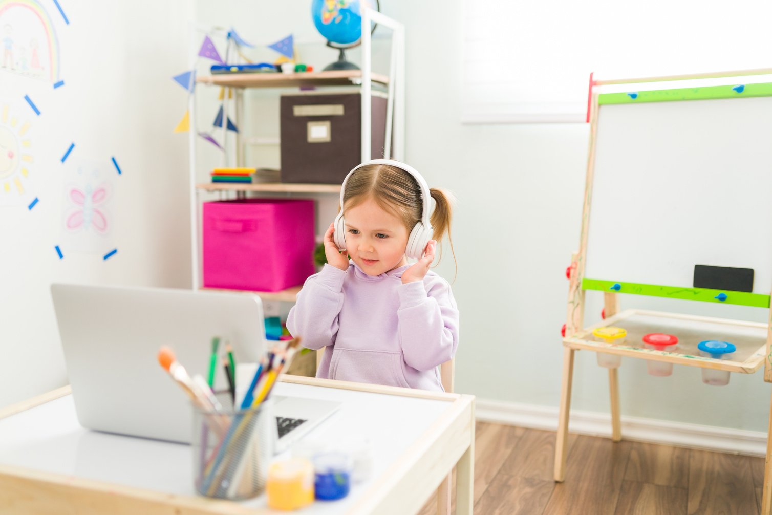 Cute preschooler having an online virtual class