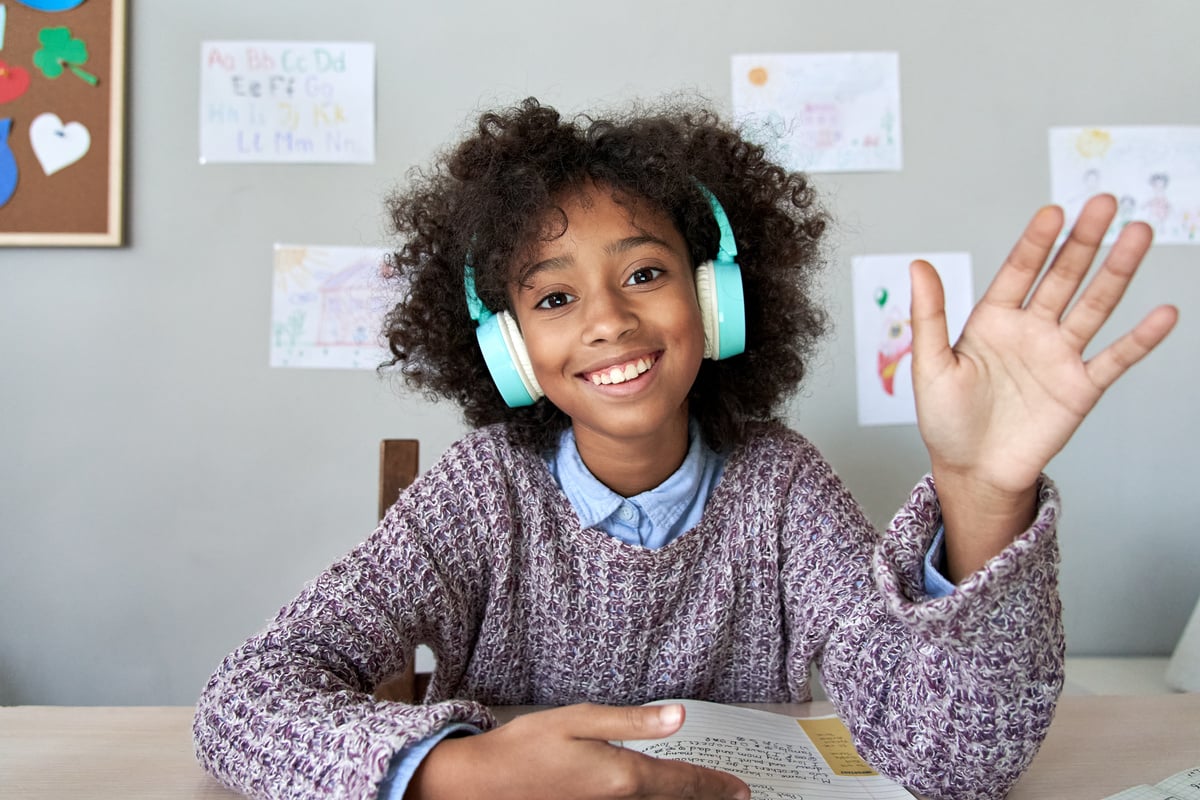 Happy African Kid Girl Waving Hand Video Calling Remote Learning, Headshot.